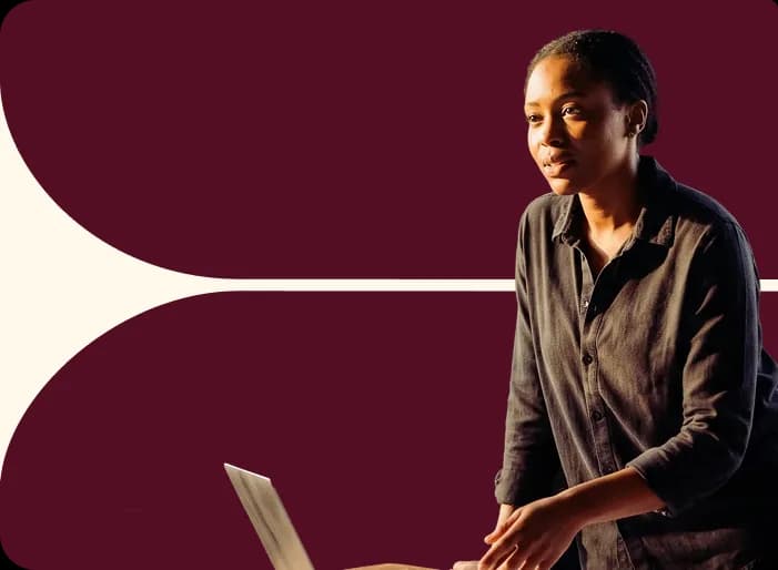 A colleague seated with a laptop