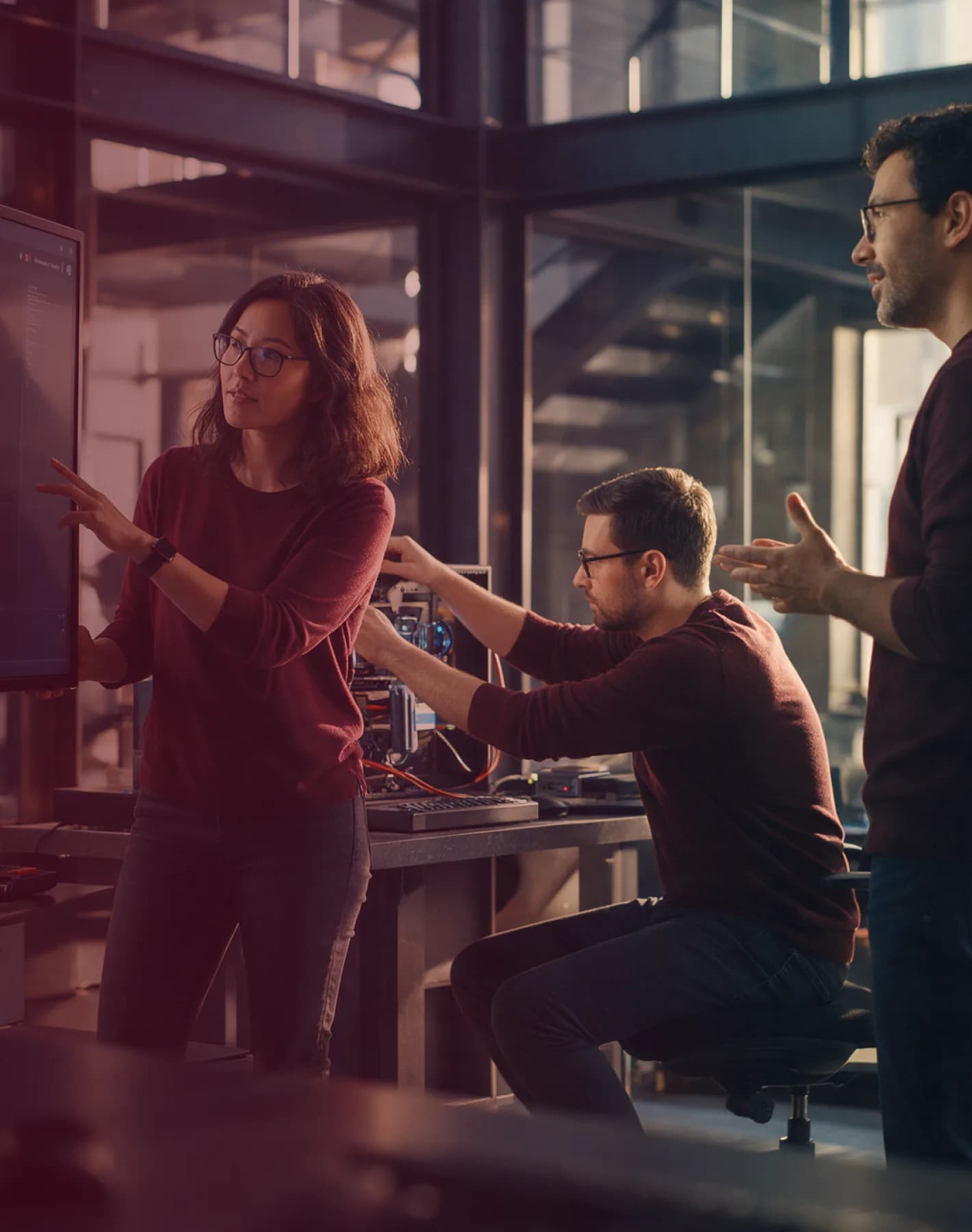 A technology team collaborating around computer equipment